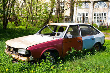 Old rusty Soviet car with broken glass.