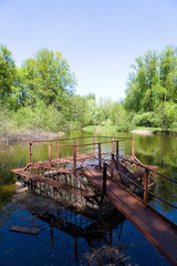 An old structure for draining water on a pond.