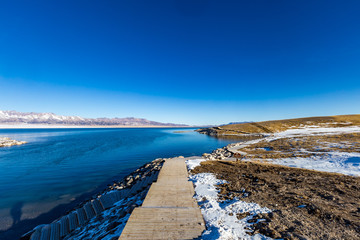 "  The frozen Sailimu lake with snow mountain background at Yili, Xinjiang of China"