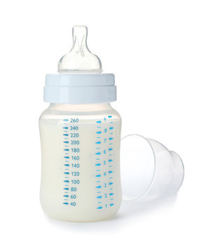 Baby bottle with milk on white background
