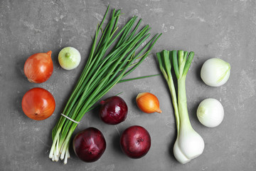 Flat lay composition with fresh onions on grey background, top view