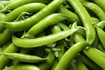Many fresh green peas as background, top view