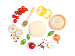 Dough and ingredients for pizza on white background, top view