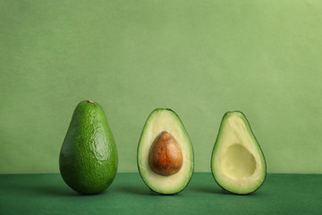 Composition with ripe avocados on color background © New Africa
