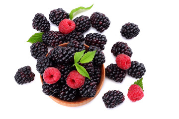 blackberries with raspberries in wooden bowl isolated on white background top view
