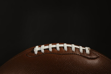 New American football ball on dark background