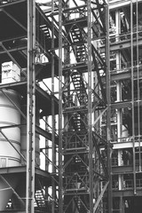 Fototapeta premium working installer industrial climber working at a height on the installation of metal structures, black and white photo