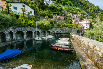 Fototapeta na wymiar Small old port with boats on the lake, Cannero Riviera, Lago Maggiore
