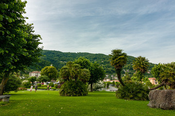 Fototapeta na wymiar Garden on the shore of Lake Maggiore, tourist on the Cannero Riviera Beach