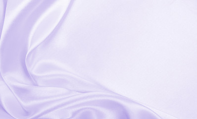 Smooth elegant lilac silk or satin texture as wedding background. Luxurious background design