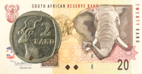 2 south african rand coin against 20 south african rand banknote
