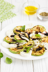 Salad slices of fried zucchini with mozzarella, light summer snack