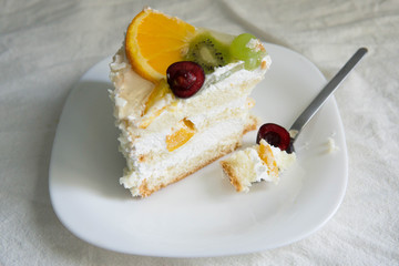 Yoghurt cake with white cream and fresh fruits