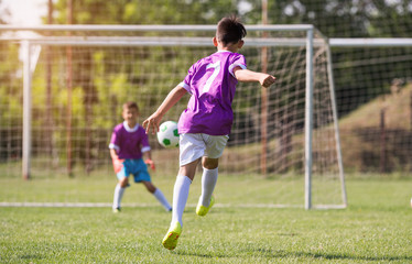 Young children players football match on soccer field