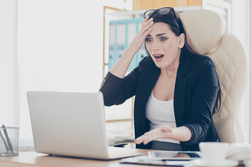 Portrait of shocked stressed woman gesturing with hands at laptop having bad news information...
