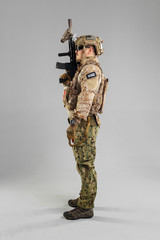 Special forces soldier with rifle on white background.