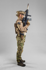 Special forces soldier with rifle on white background.