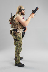 Special forces soldier with rifle on white background.