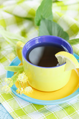 Cup of herbal tea with linden blossoms and lemon