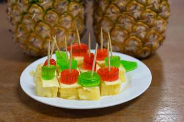 Fresh pineapple fruit with sheet and jelly on table

