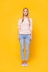 Full size fullbody portrait of strict charming girl wearing pants shoes sexy outfit looking at camera isolated on bright vivid yellow background