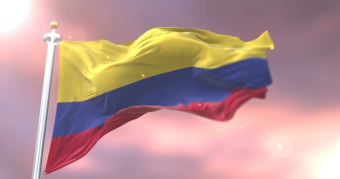 Colombia flag waving at wind in slow at sunset, loop