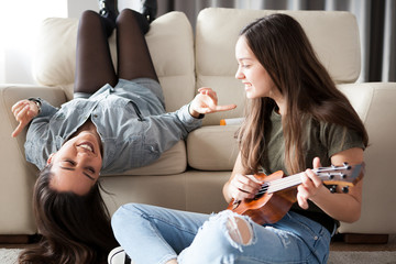 Fun and happiness in the house. Two sisters are enjoying time together