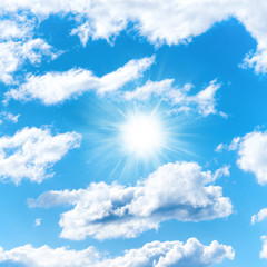 Naklejka na ściany i meble Sun on blue sky with clouds as nature background