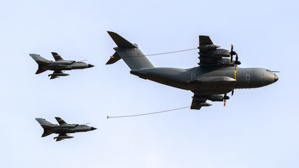 Military tanker aircraft aerial refuelling two air force fighter bomber jets 