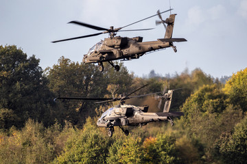 Military attack helicopters in low flight