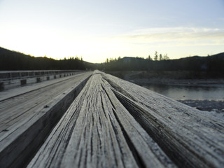 Obraz na płótnie Canvas Wooden bridge over the river Oka Sayanskaya