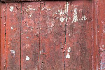 Old wooden background with remains of pieces of scraps of old paint on wood