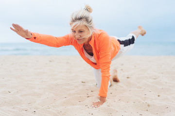 Mature blond woman working out doing yoga