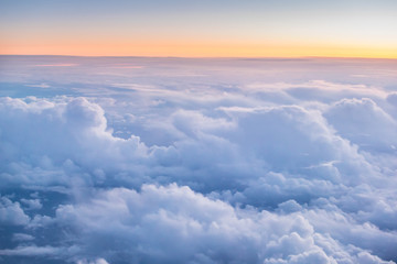 Naklejka na ściany i meble Beautiful sunset with cloudy sky from the airplane window.