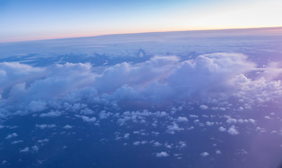 Fototapeta na wymiar Beautiful sunset with cloudy sky from the airplane window.