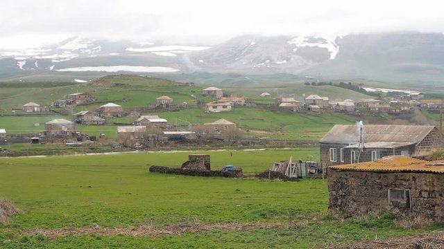 Village near border between Armenia and Georgia. Oven chimney smokes overcast
