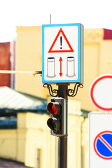 close up view of road signs and semaphore with blurred background