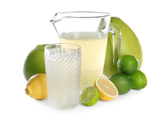 Glassware with delicious citrus juice and fresh fruits on white background