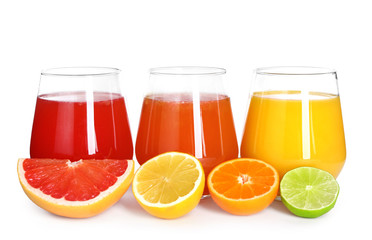 Glasses with delicious citrus juice and fresh fruits on white background