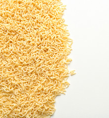 Raw alphabet pasta on white background