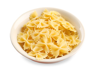 Bowl with raw pasta on white background