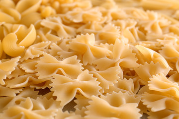 Uncooked pasta as background, closeup