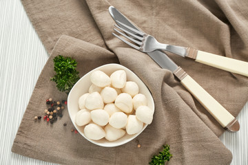 Bowl with mozzarella cheese balls on cloth