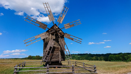 Fototapeta premium Old historic wooden windmill in a field