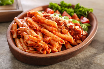 Plate of tasty pasta with bolognese sauce on table