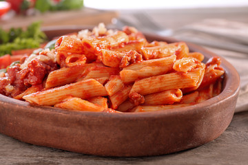 Plate of tasty pasta with bolognese sauce on table, closeup