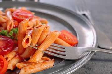 Tasty pasta with tomato sauce on plate, closeup