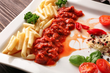 Plate of delicious pasta with bolognese sauce on table, closeup