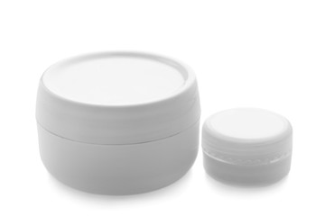 Jars with skin care cosmetics on white background