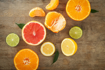 Fototapeta na wymiar Flat lay composition with ripe citrus fruits on wooden background